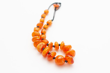 amber beads on white background