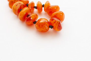 amber beads jewelry on white background