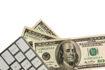 several hundred dollar bills and a gray computer keyboard isolated on the white background, copy space for text. Financial, business and technology concept.