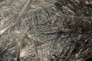 close-up of dark packaging polyethylene texture background. Polyethylene (PE) is the most common plastic produced in the world.