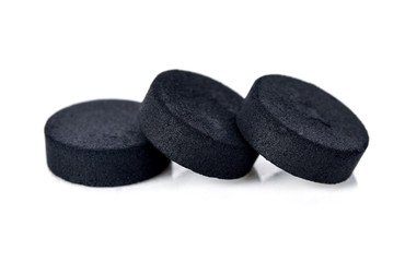 Activated charcoal tablet pills isolated on white background