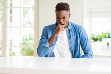 Handsome african american man at home feeling unwell and coughing as symptom for cold or bronchitis. Healthcare concept.