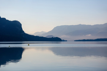 Morning fog over scenery lake Wolfgangsee in Austrian Alps