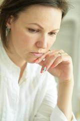 Portrait of sad young woman posing at home