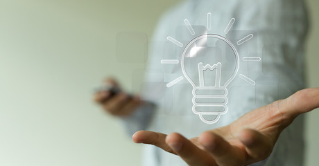  holding illuminated light bulb, idea, innovation and inspiration concept.