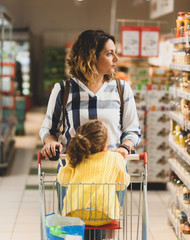 Mother and daughter shopping for groceries in supermarket. - 274016838