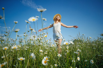 Beautiful woman in the field with flowers. 