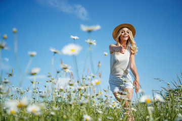 Beautiful woman in the field with flowers. 