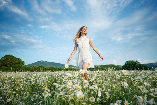 Beautiful Woman In The Field With Flowers. 