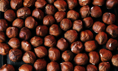 Hazelnuts on the brown wooden table.