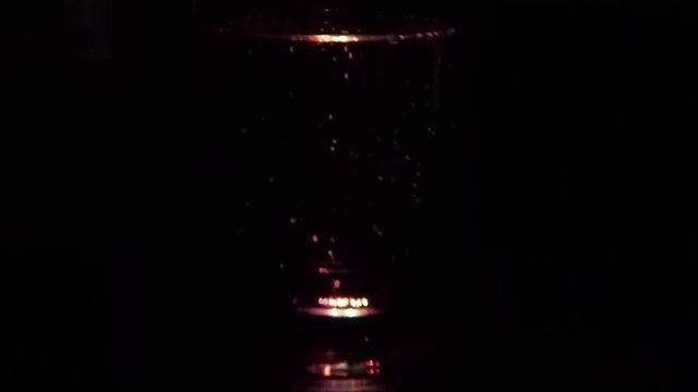 Champagne rotating in the dark black background.