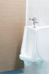 Urinals in Men toilet background.