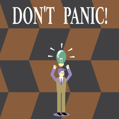 Writing note showing Don T Panic. Business photo showcasing suddenly feel so worried or frightened that you can not behave Businessman Raising Arms Upward with Lighted Bulb icon above.