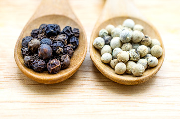 Black pepper in a wooden spoon