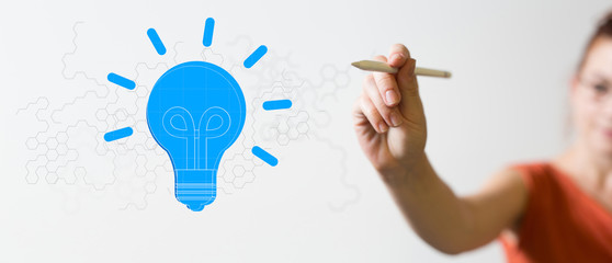 Obraz premium holding illuminated light bulb, idea, innovation and inspiration concept.