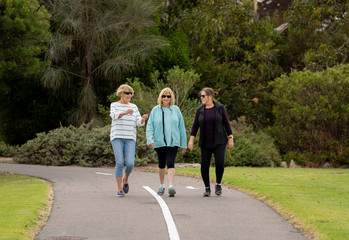 Happy active senior citizen women walking and training together in healthy retirement lifestyle