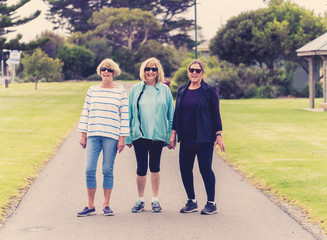 Happy active senior citizen women walking and training together in healthy retirement lifestyle