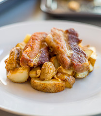 Pork ribs with roasted potatoes and garlic close up