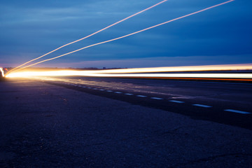 Night road and light from the headlights outside the city