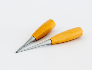 Two awls  for shoemakers with a wooden handle on a white background