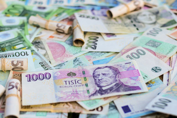 Obraz na płótnie Canvas Scattered Euro and Czech Koruna bills