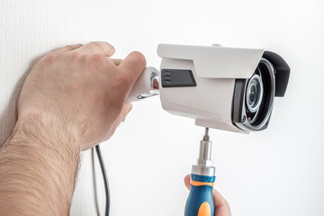 Technician worker installing video CCTV camera
