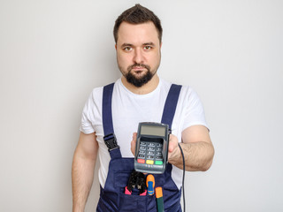 Man with tools holding bank payment terminal