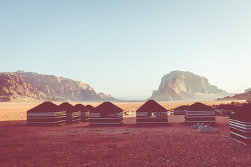 Red sand desert and Bedouin camp at sunny summer day in Wadi Rum, Jordan. Middle East.