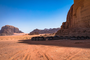 Red sand desert and Bedouin camp at sunny summer day in Wadi Rum, Jordan. Middle East.