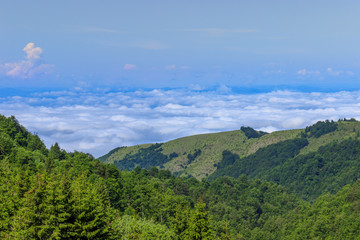 Picturesque view of the green hills, blue sky and thick clouds