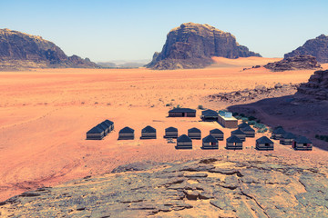 Red sand desert and Bedouin camp at sunny summer day in Wadi Rum, Jordan. Middle East.