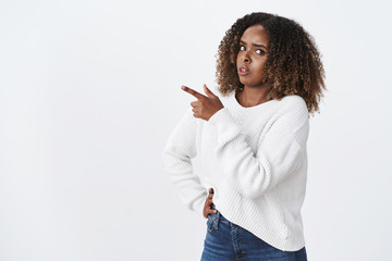 Suspicious hesitant unsure triggered african-american questioned woman plus-size wear white sweater look doubtful ask question pointing upper left corner unsure, have doubts, studio background - obrazy, fototapety, plakaty