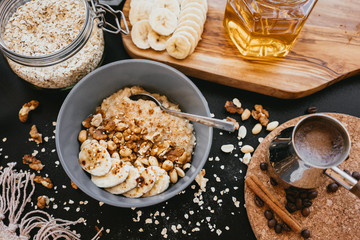 Healthy breakfast oatmeal bowl with banana and nuts