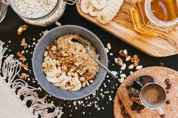 Healthy breakfast oatmeal bowl with banana and nuts