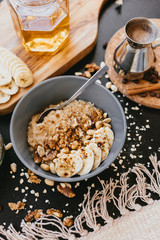 Healthy breakfast oatmeal bowl with banana and nuts