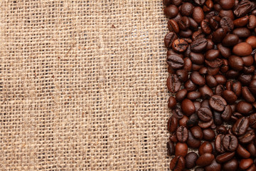 Fototapeta premium Coffee beans on burlap background