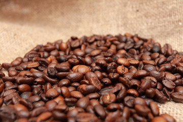 Coffee beans on burlap background