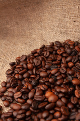 Coffee beans on burlap background