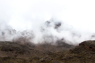 Dramatic landscape with mountain in the fog and clouds