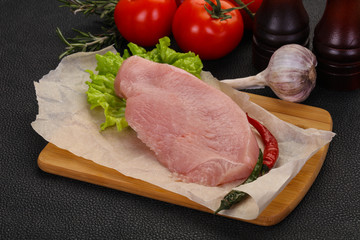 Raw Turkey steak served rosemary