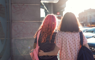two lesbian girls, couple kiss romantically on the street in the city show love to each other gay pride LGBT pride world movement lesbian, gay, bisexual, transgender proud of their sexual orientation