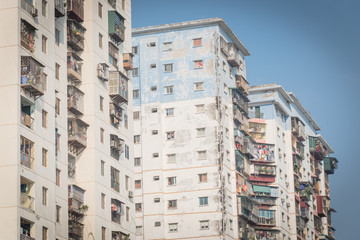 Typical condos with hanging clothes over blue sky in Hanoi, Vietnam