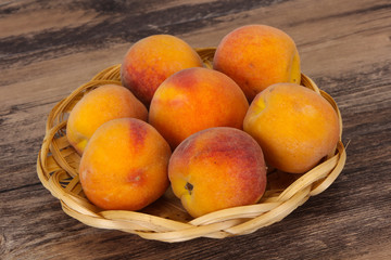 Peach heap in the wooden basket