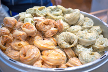 Delicious steamed round shaped dumplings in South Korea traditional market, special korean street food cuisine, close up, bokeh, copy space