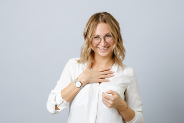 Portrait of laughing woman standing over gray