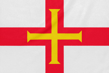 Flag of Guernsey on textured fabric. Patriotic symbol