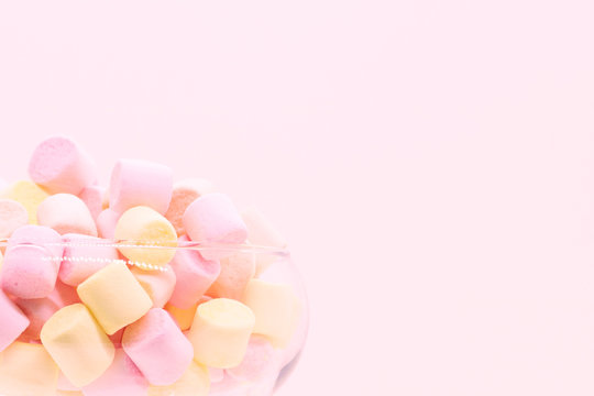 Marmellow air marshmallow close-up on a pink background, pastel colors, light dessert, place for text