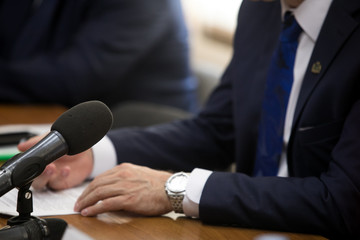 Press conference. Public speaker giving talk to Television camera. News conference. An event with a...