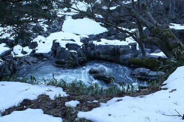 激流の川と積雪する渓谷
