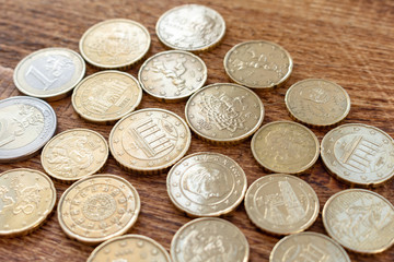 coins euro pile pack heap on a wooden background with space for an inscription mock up selective focus close up